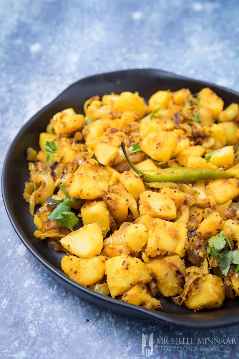 A bowl of yellow potatoes called aloo ki sabji