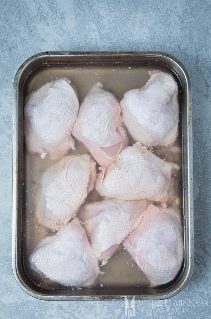 Raw Chicken Thighs in brining liquid 