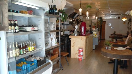 The interior of a cafe with a wooden bar