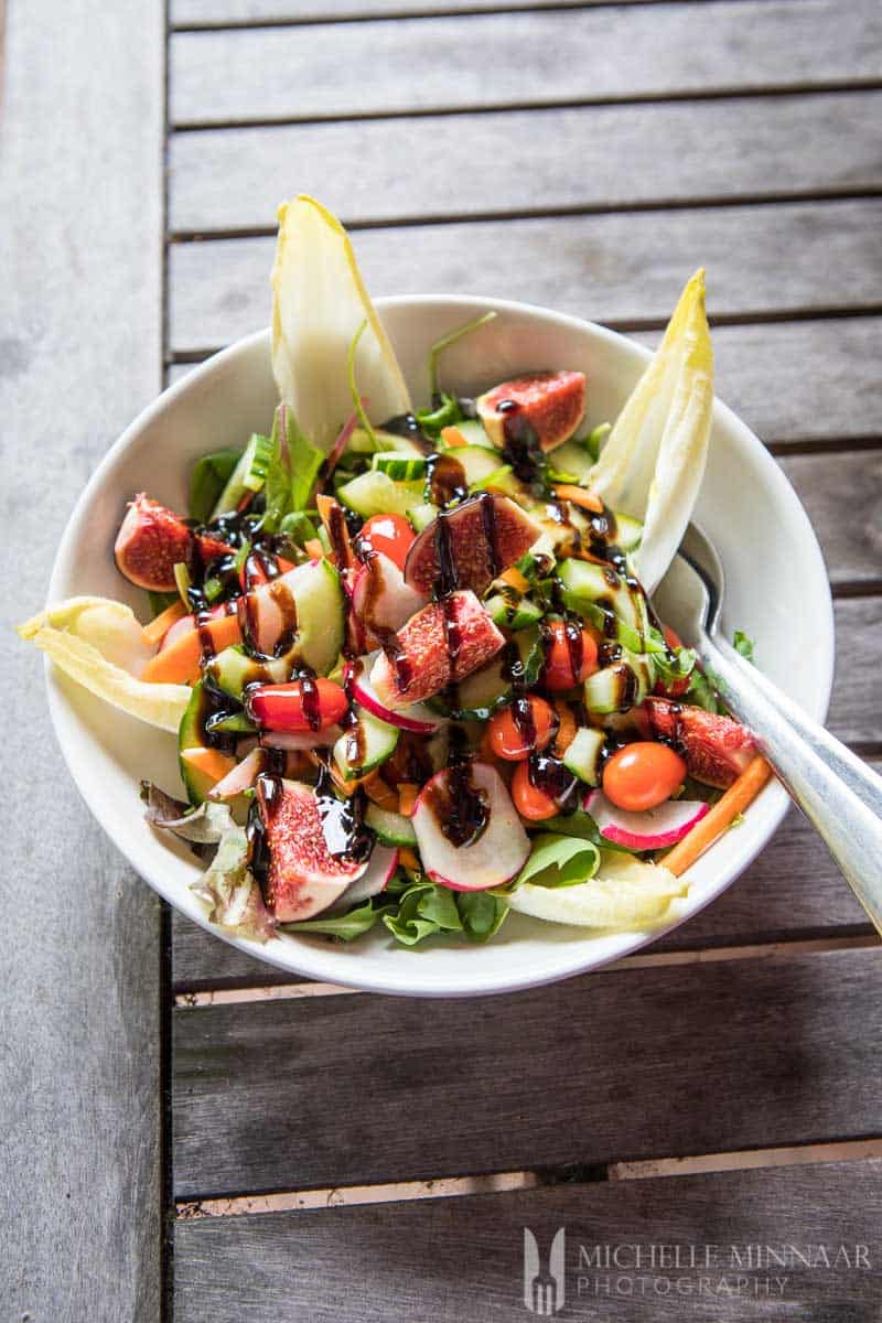 A fig and endive salad with a balsamic glaze