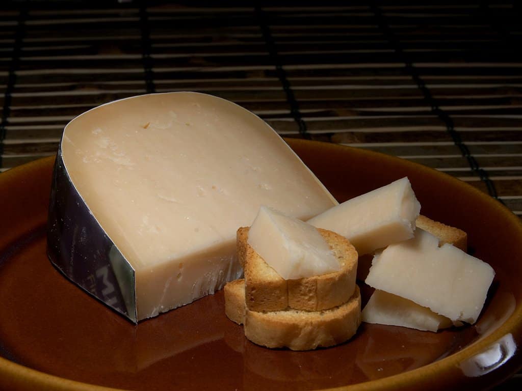 Gouda cheese on a wooden board.