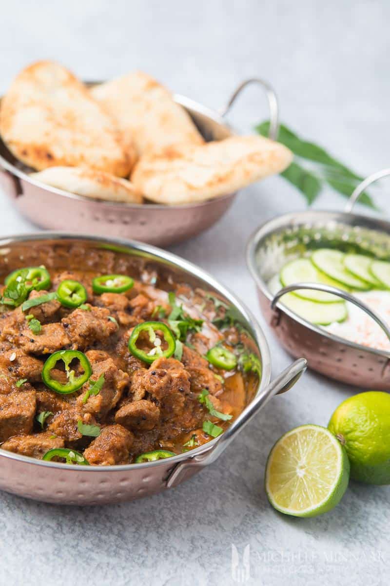 A close up of lamb bhuna in a silver bowl 