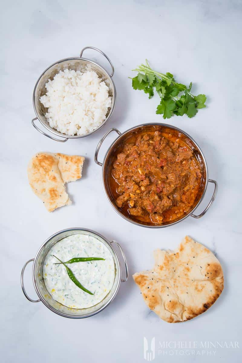 A complete Indian meal, Lamb madras, white rice, cacik dip and roti