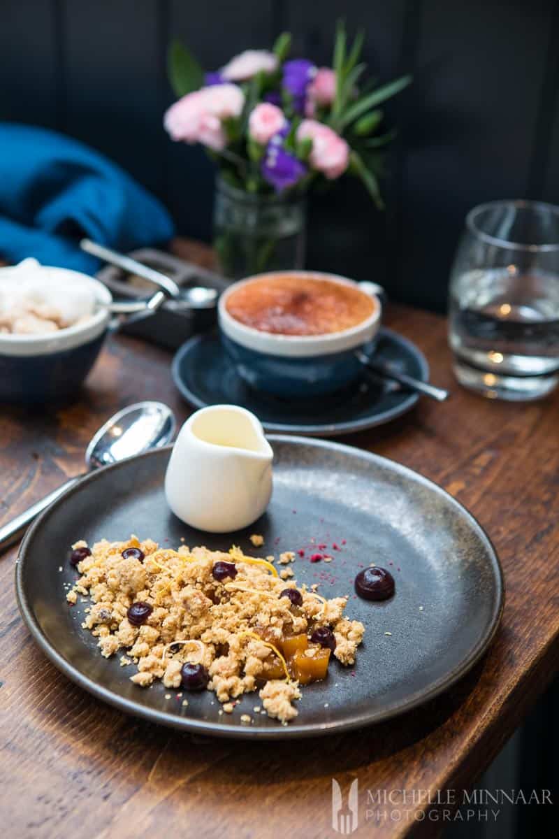 Pear crumble, blackberry coulis and orange custard