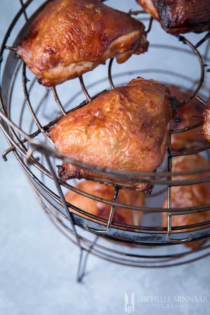 Chicken Thighs lined up on a smoker