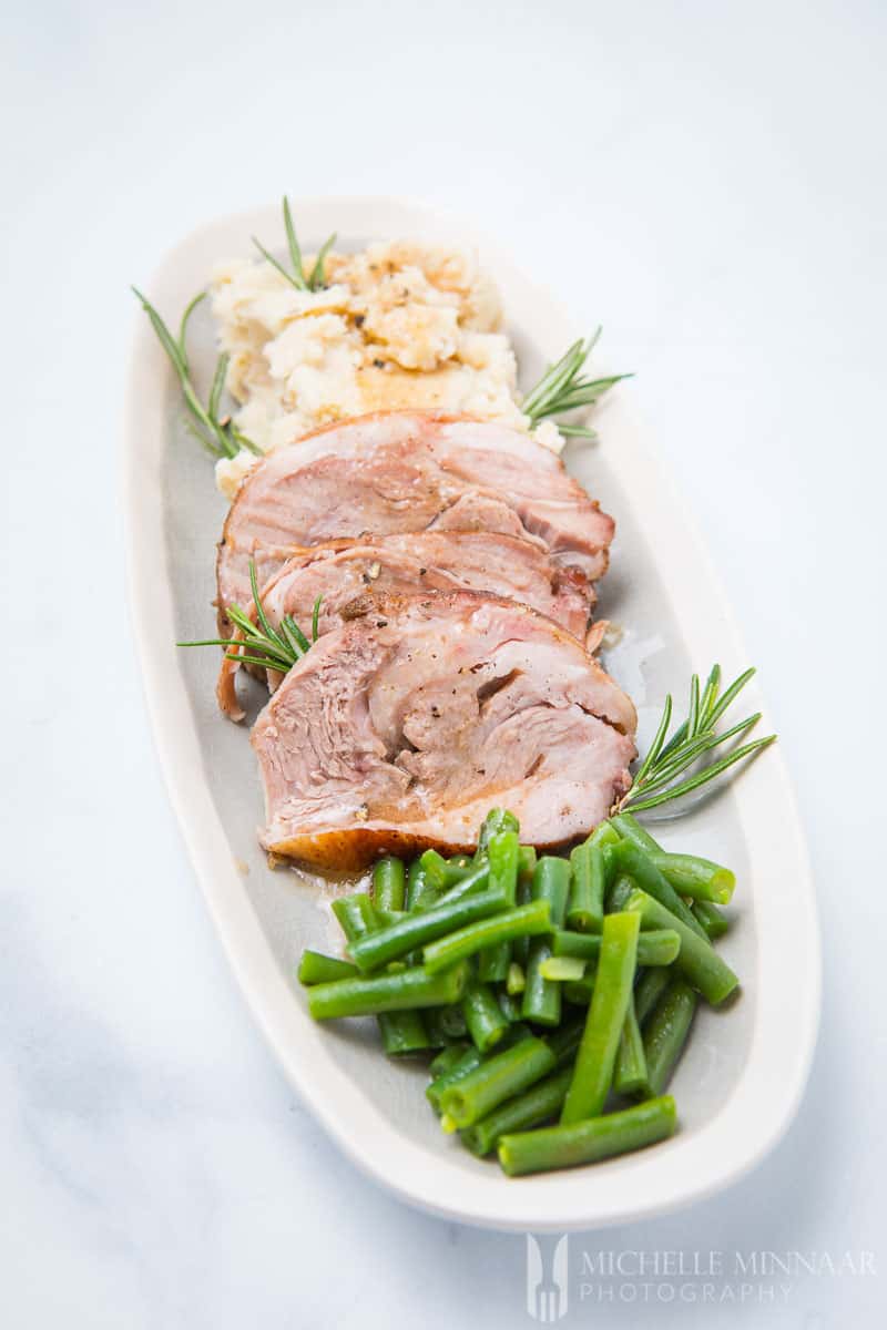 A plate of sous vide lamb shoulder with green beans