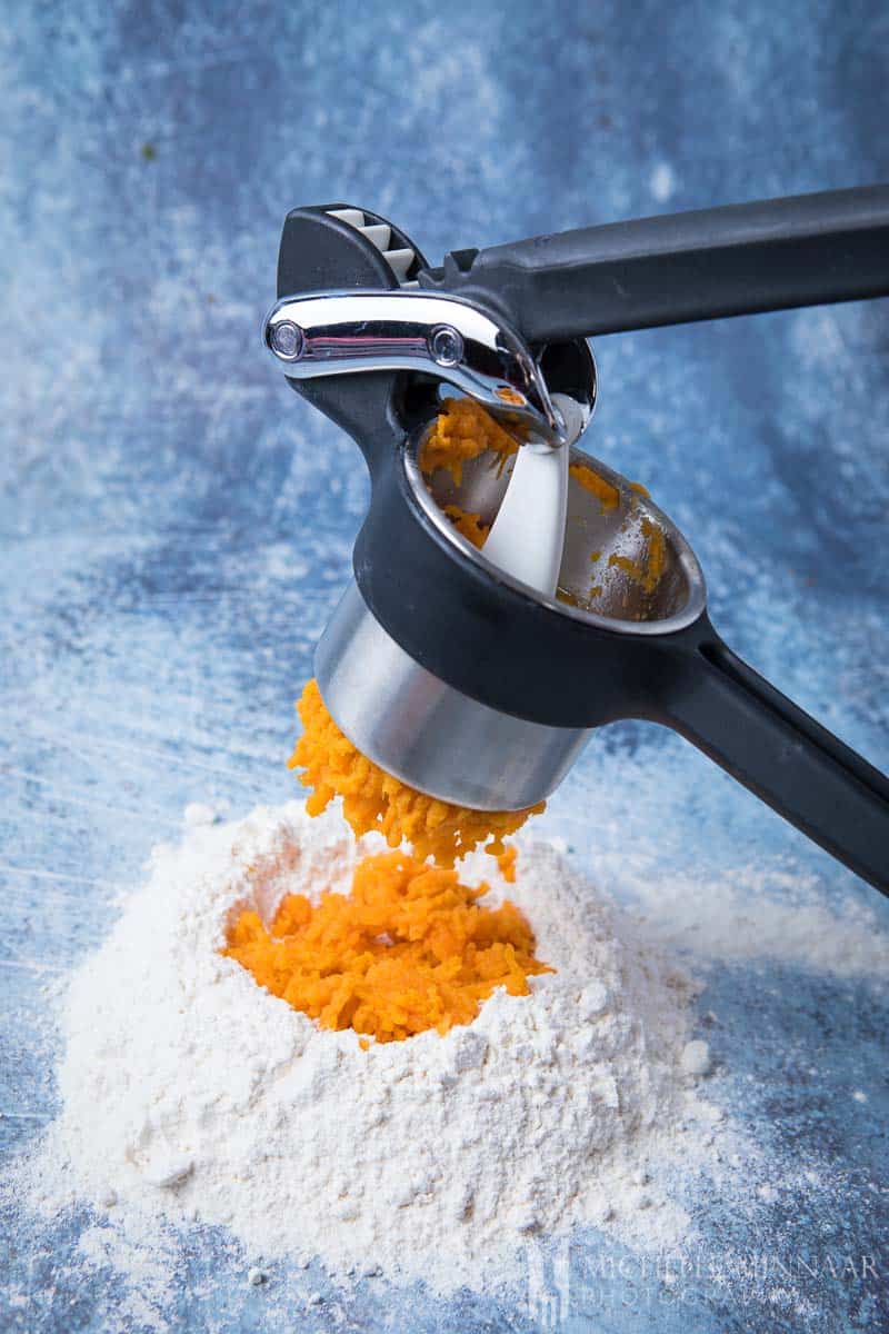 Sweet Potato being ground up onto some white flour
