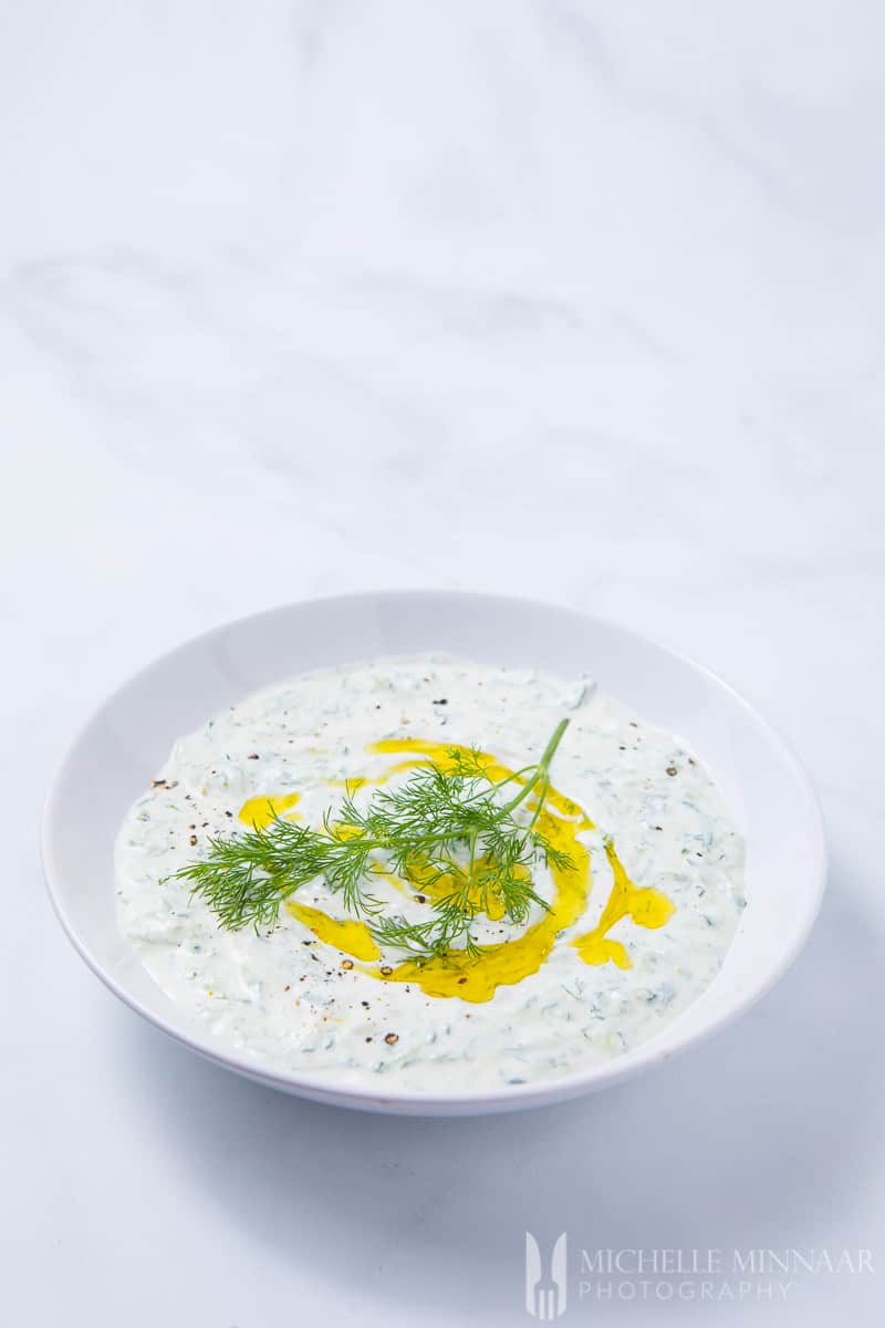 A bowl of Cacik with olive oil drizzled on top 