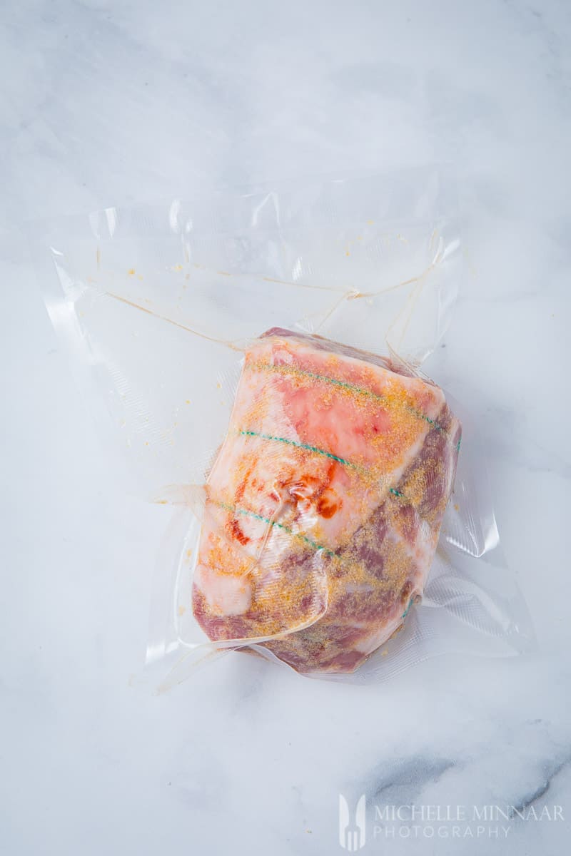 Lamb shoulder wrapped in plastic