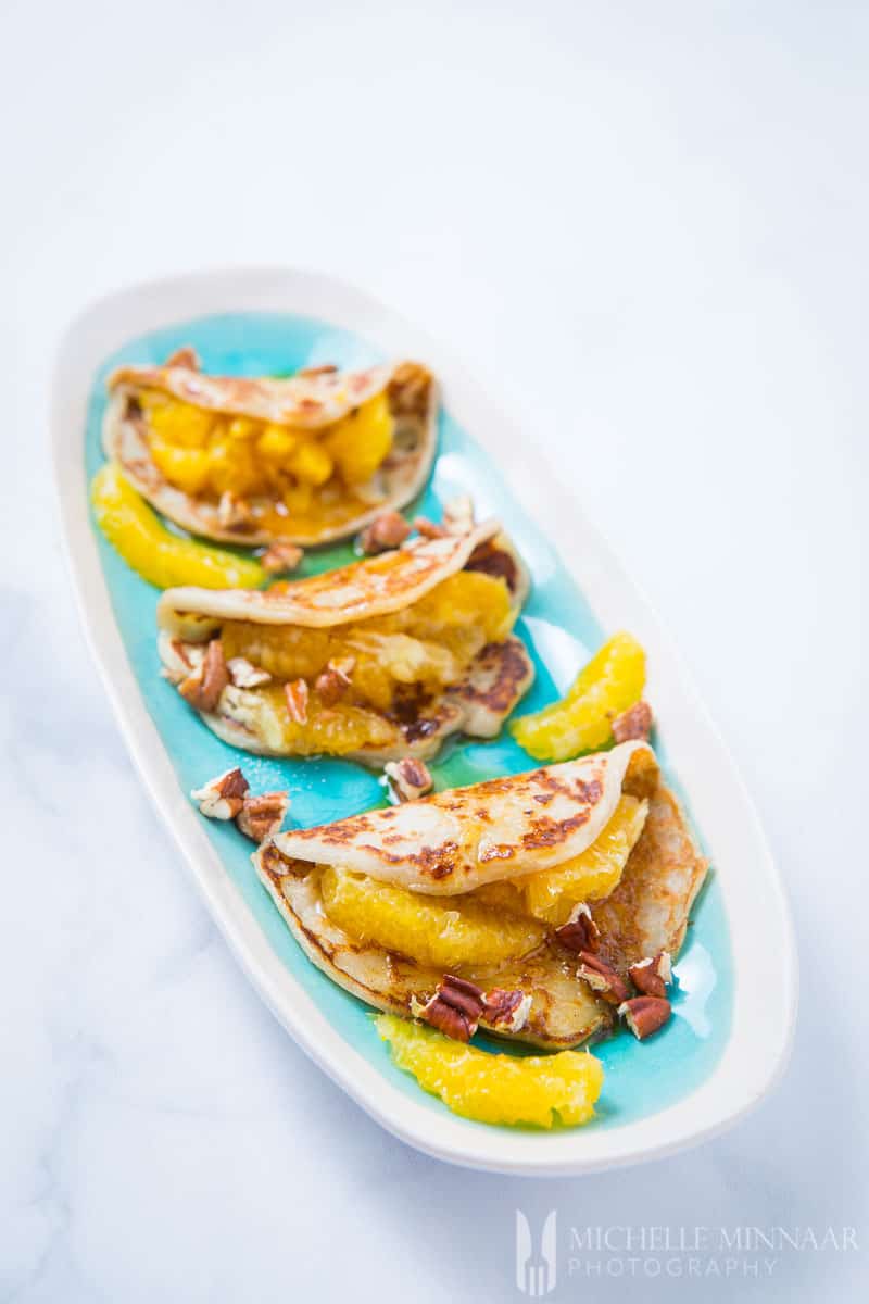 A close up of folder vegan sweet potato pancakes stuffed with peaches and walnuts