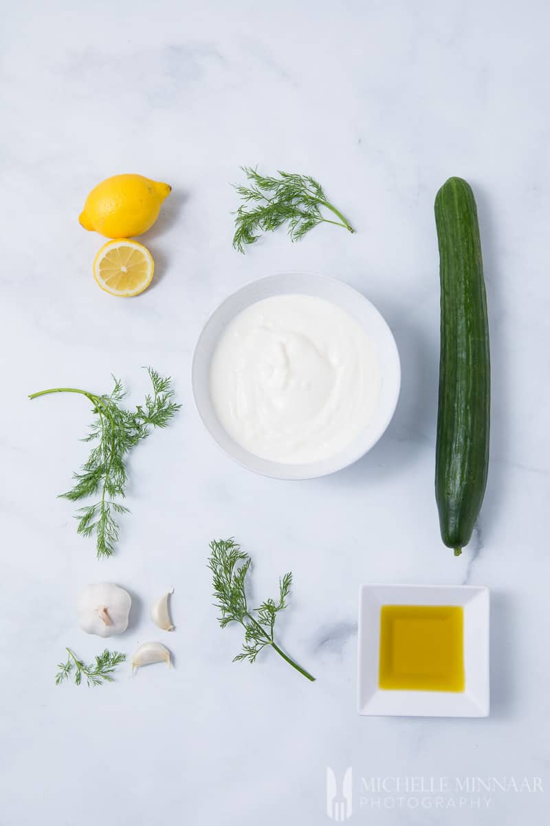 Ingredients to make cacik : cucumber, yogurt, lemons, dills, garlic 