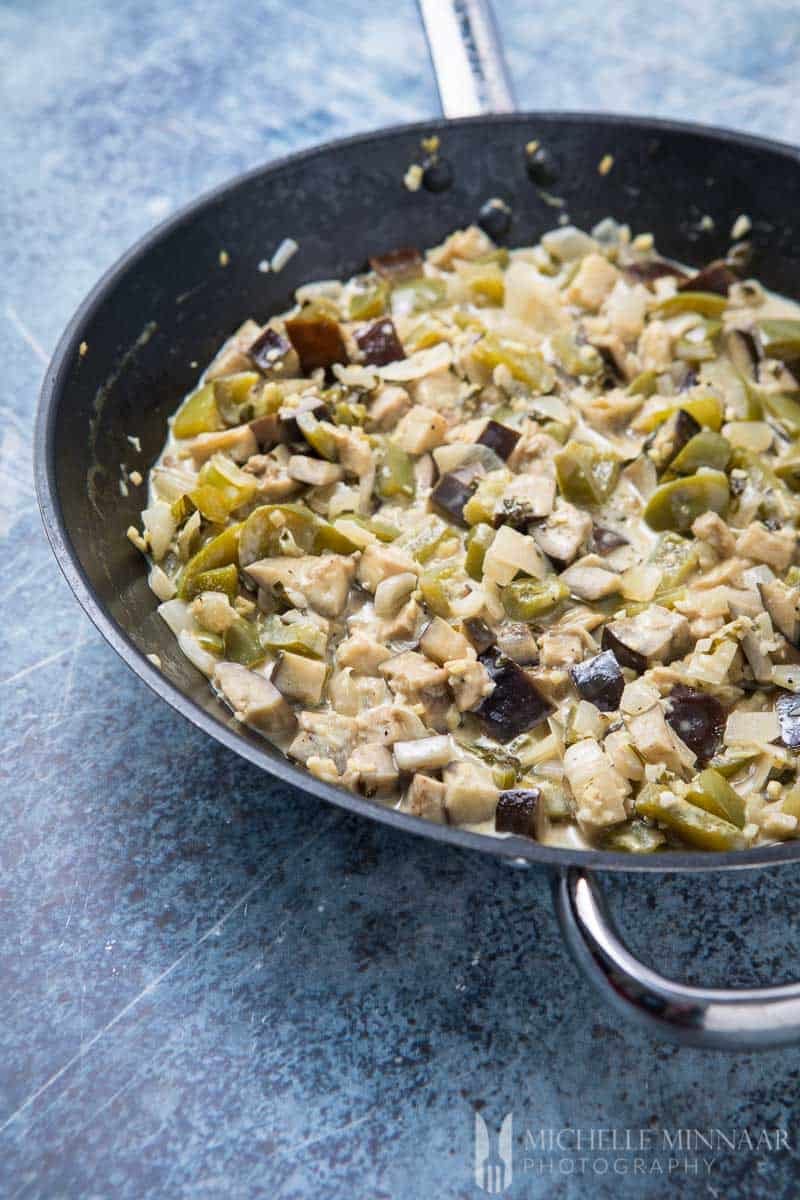 A close up of Aubergine curry in a saute pan 