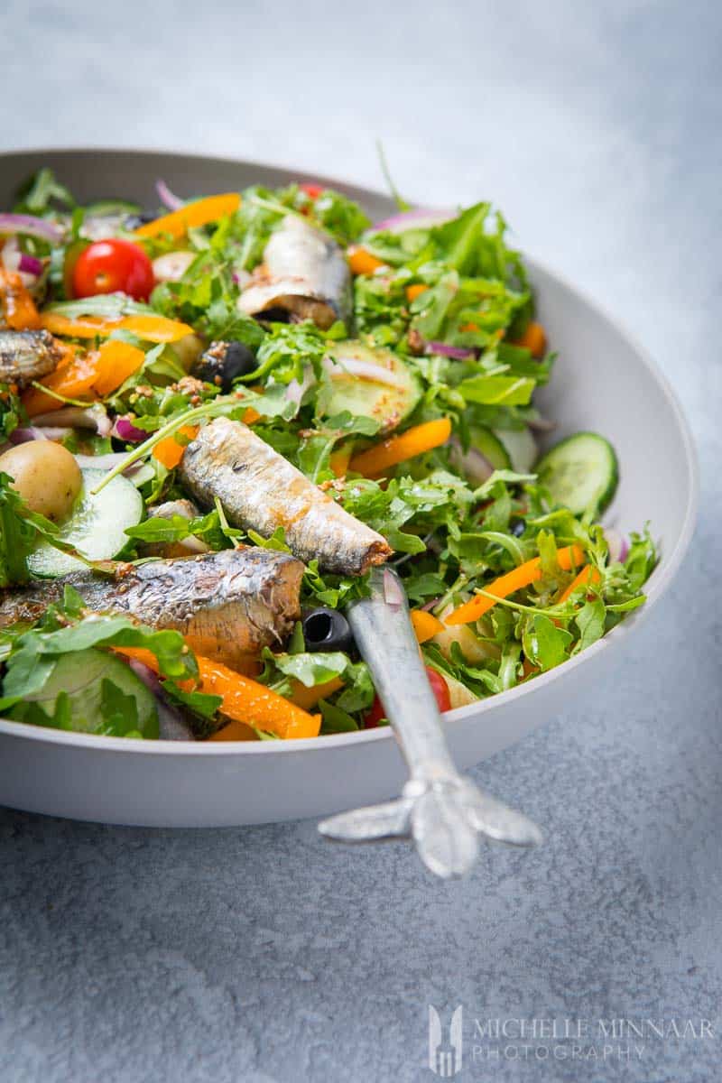 A close up of sardines on a bed of lettuce
