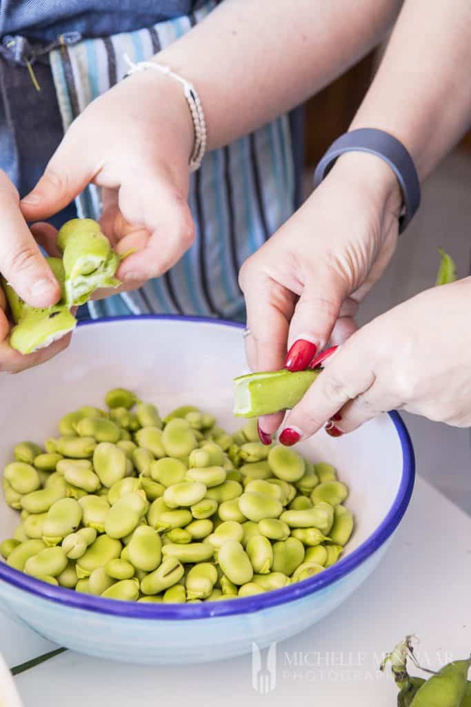 A close up of green broad beans in a bowl 