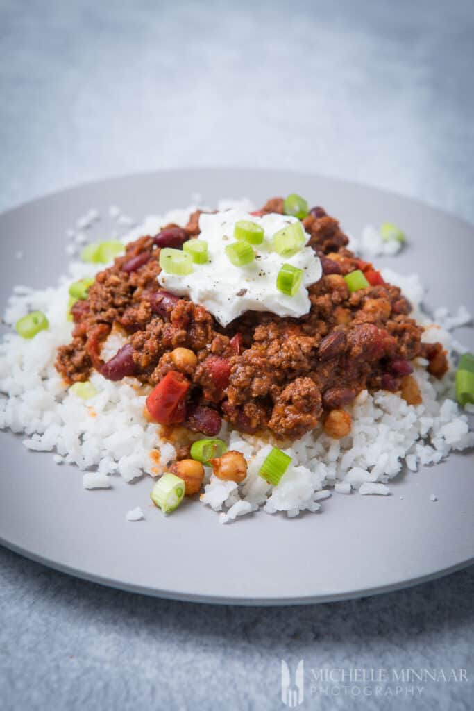 Venson chili on top of a bed of white rice 