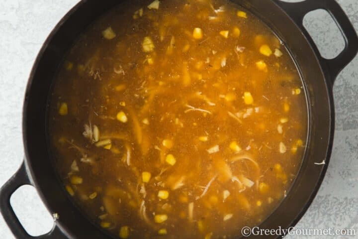 Stock, chicken and sweetcorn in a pot.