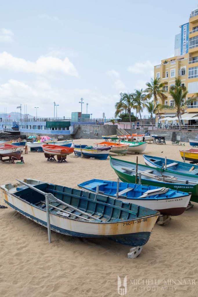 Row boats lined up on the beach 