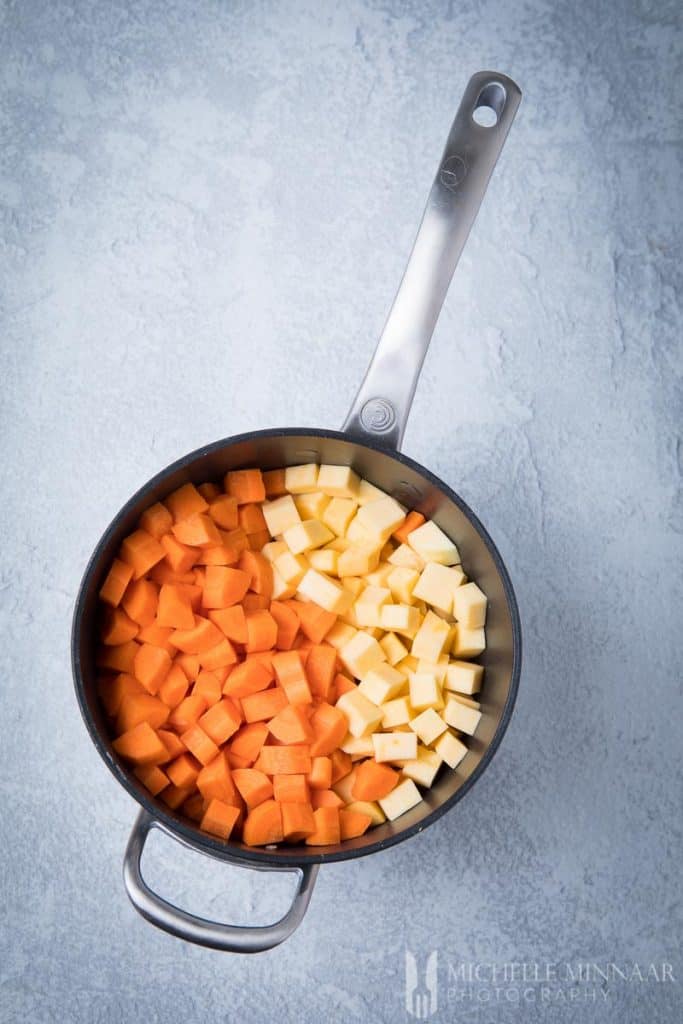 Cubes of carrot and swede in a stockpot