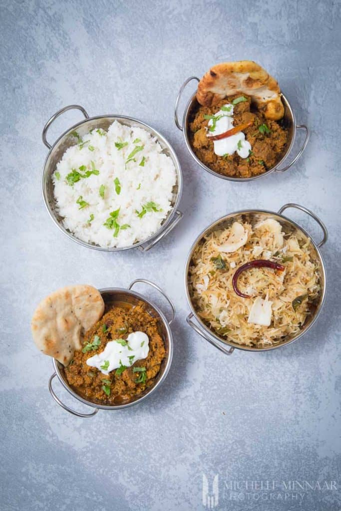 An indian dinner, 4 bowls of food 