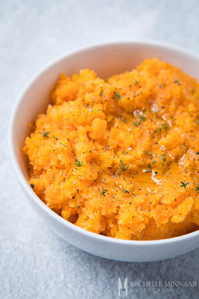 A bowl of orange carrot and swede mash