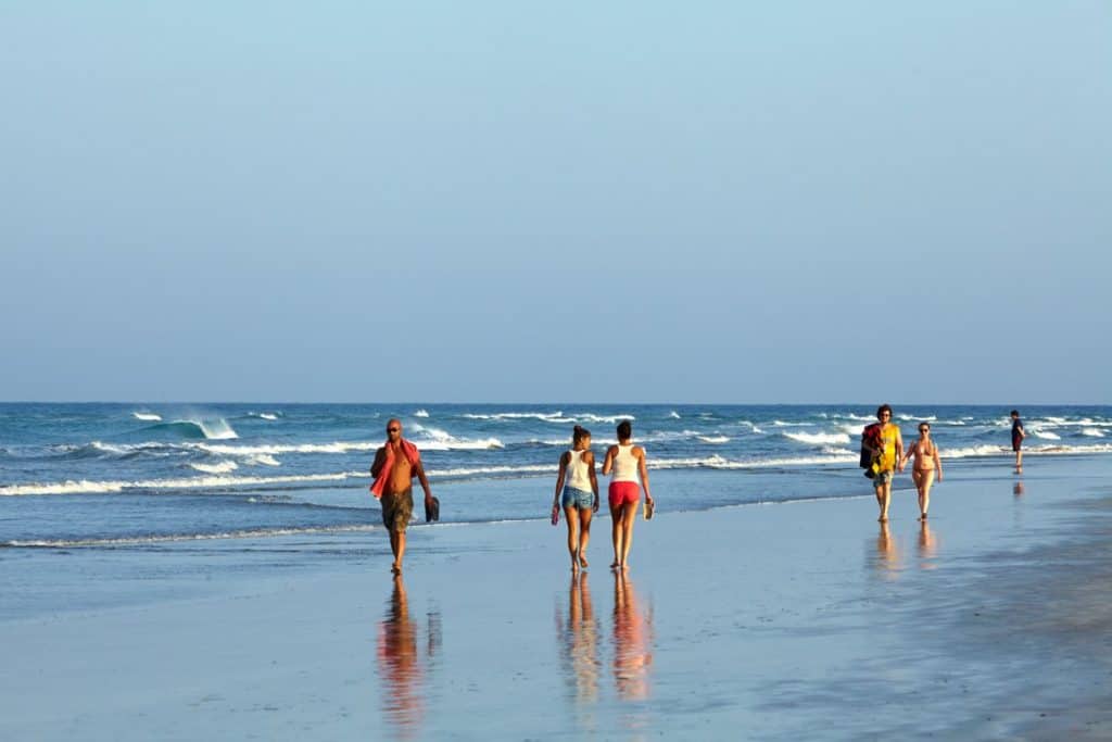 People walking on a beach in spain 