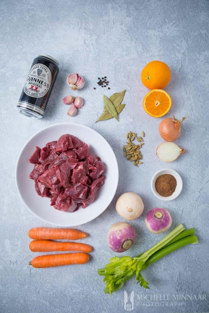 Ingredients to make venison stew : a can of guiness, raw venison, carrots, spices