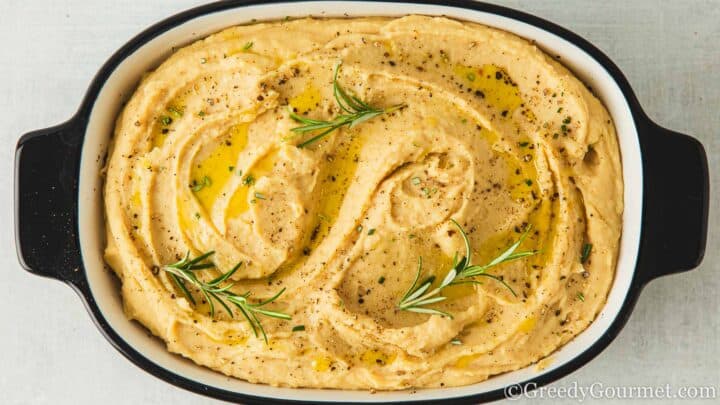 Butter bean mash in a grey dish.