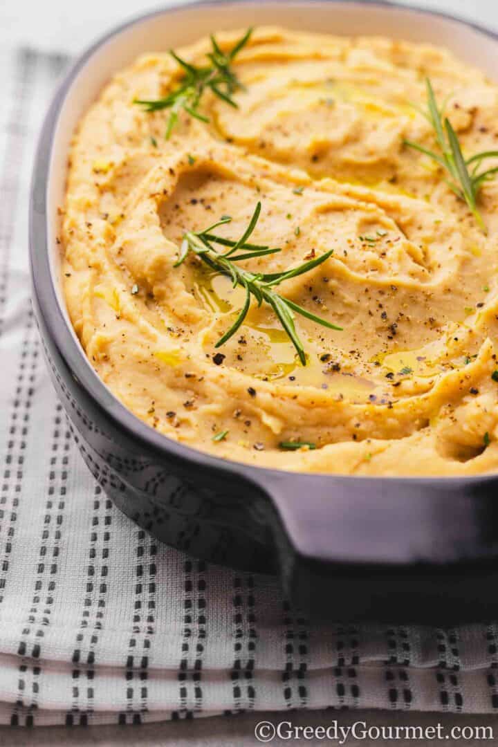 Butter bean mash in a grey dish.