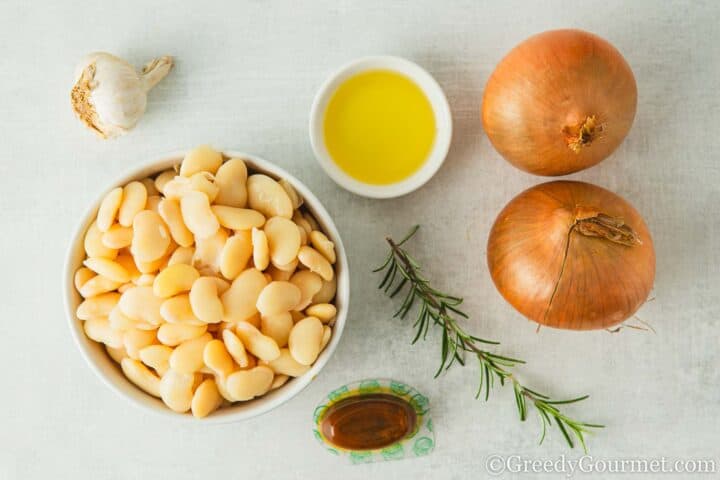 Ingredients for  butter bean mash on a table.