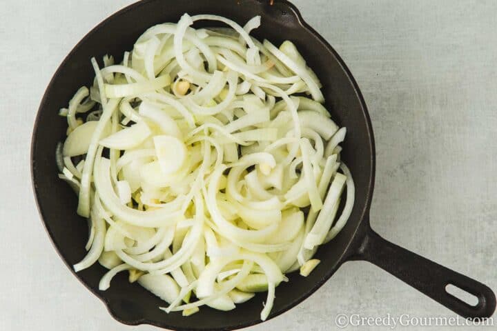 softening onions in a pan.