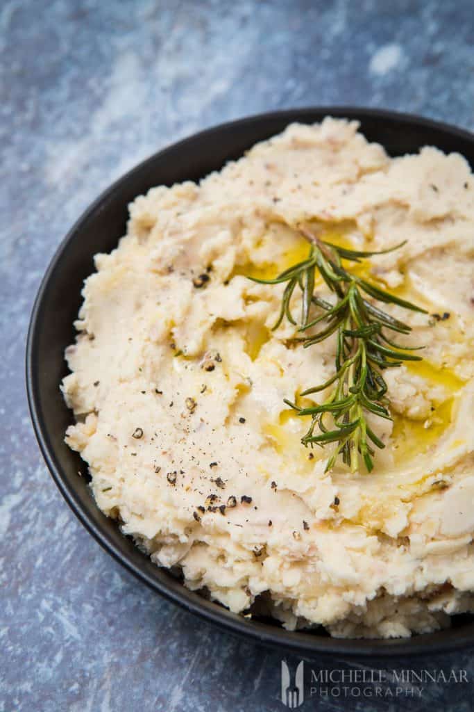 A close up of a bowl of white butter bean mash