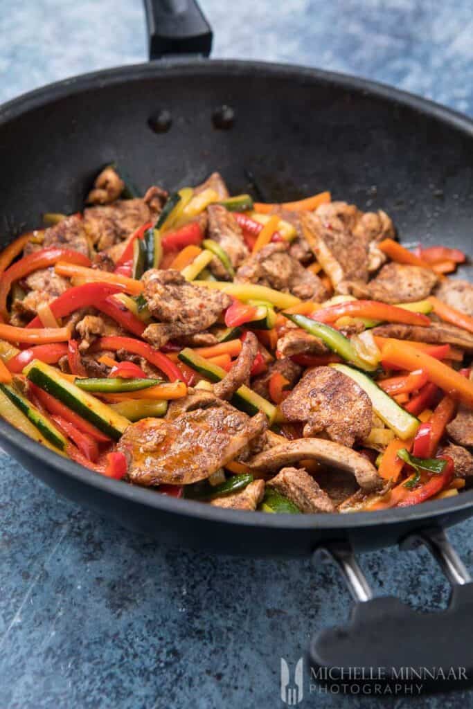 sweet chili chicken stir fry in a pan 