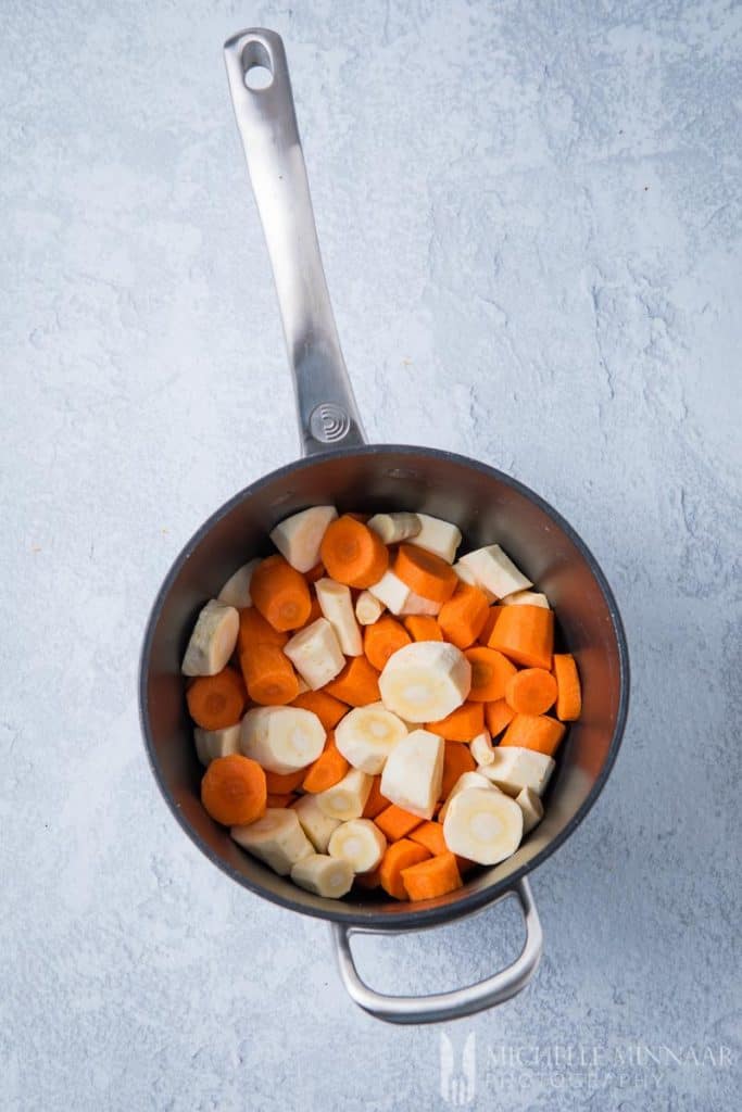 Sliced carrot and parsnip in a pan 