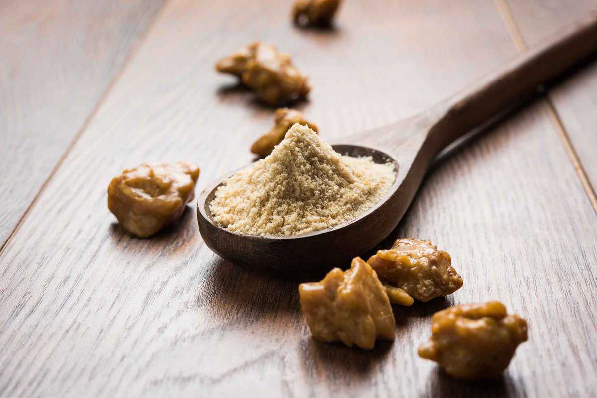 White Asafoetida poweder in a wooden spoon 