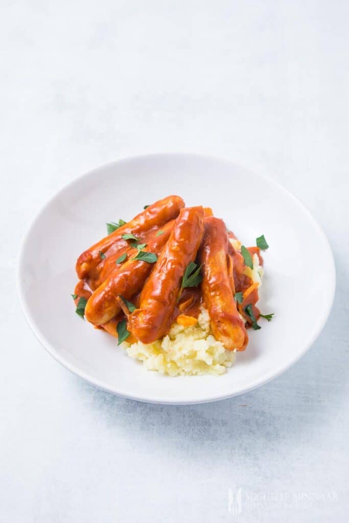 A plate of orange devilled sausages