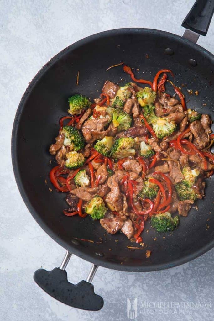 An aerial view of lamb stir fry in a saute pan 