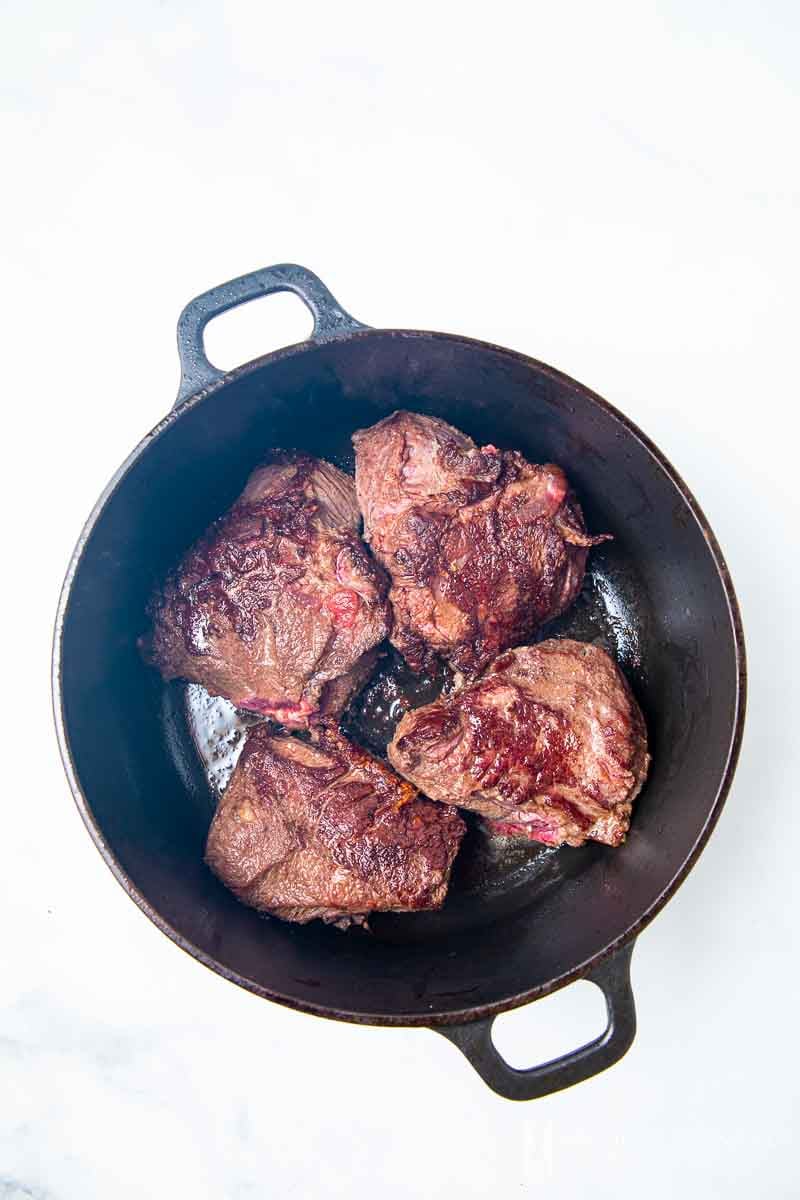 beef cheeks grilling in a pan