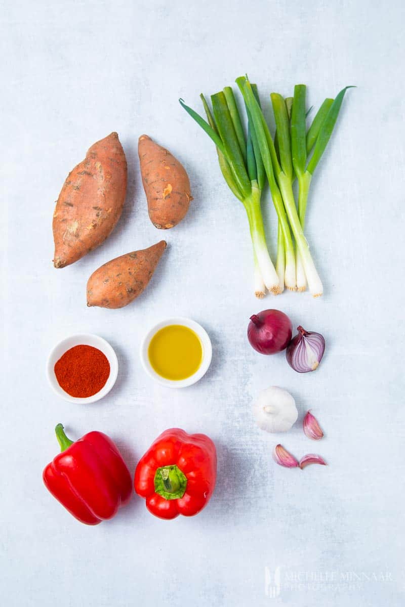 Ingredients to make sweet potato and red pepper soup: Potato Spring Onion Red Pepper Onions