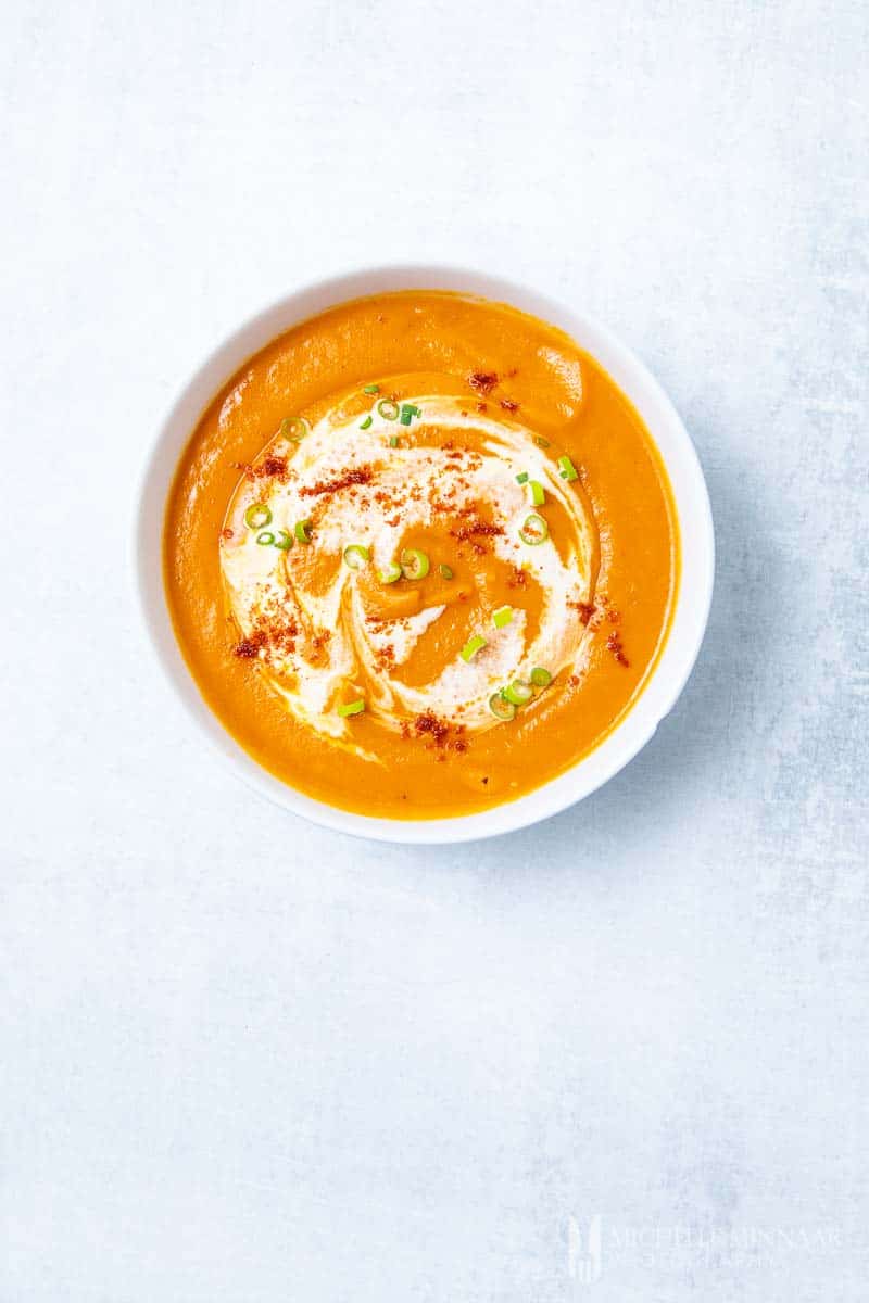 An aerial view of an orange coloured sweet potato and red pepper soup