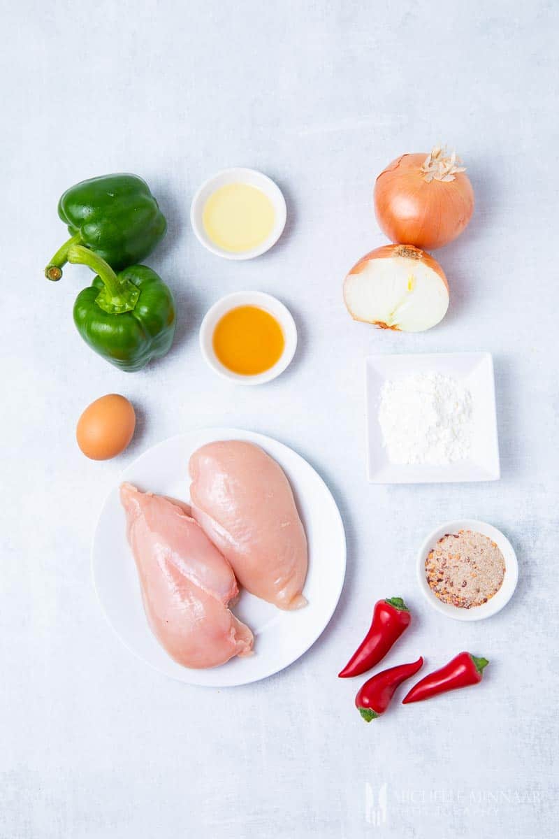 Ingredients to make salt and chili chicken :Raw chicken Green Pepper Onion Chillies