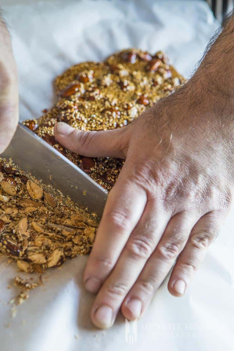 A mans hands chopping brittle