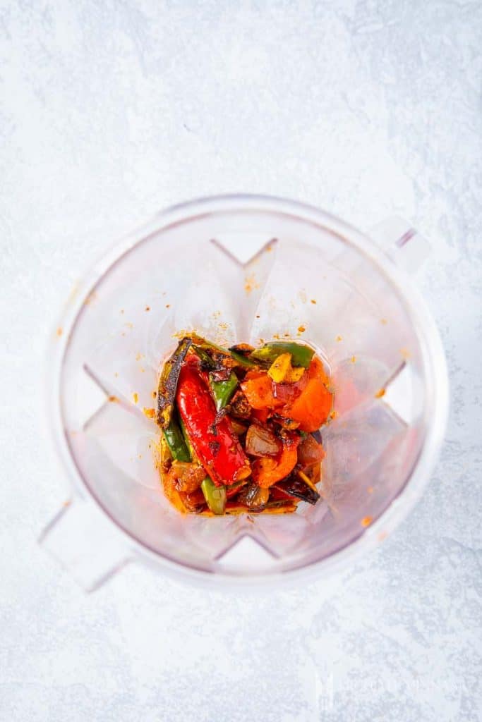 Cooked vegetables in a blender to make sambal oelek