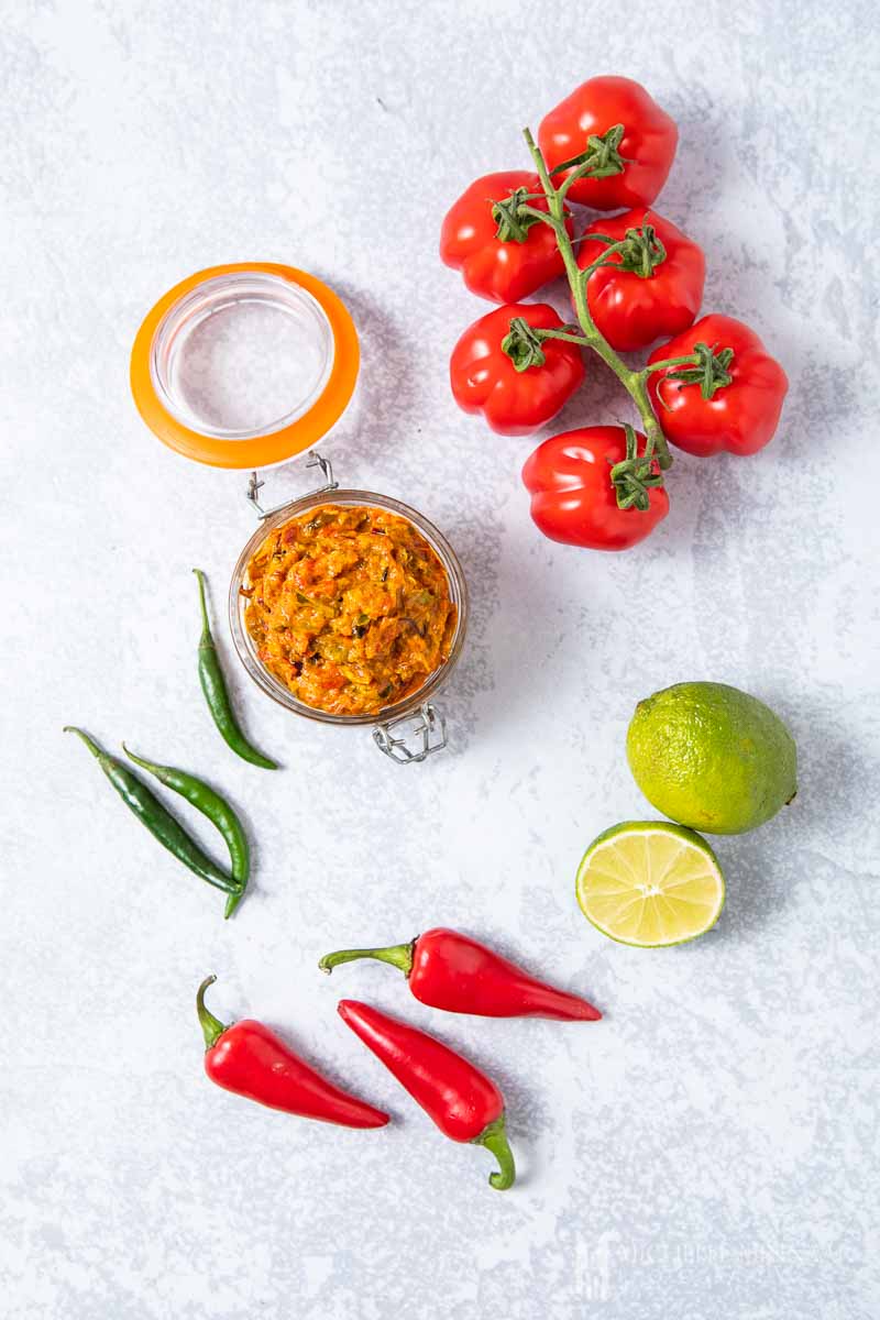 A jar of sambal oelek and peppers