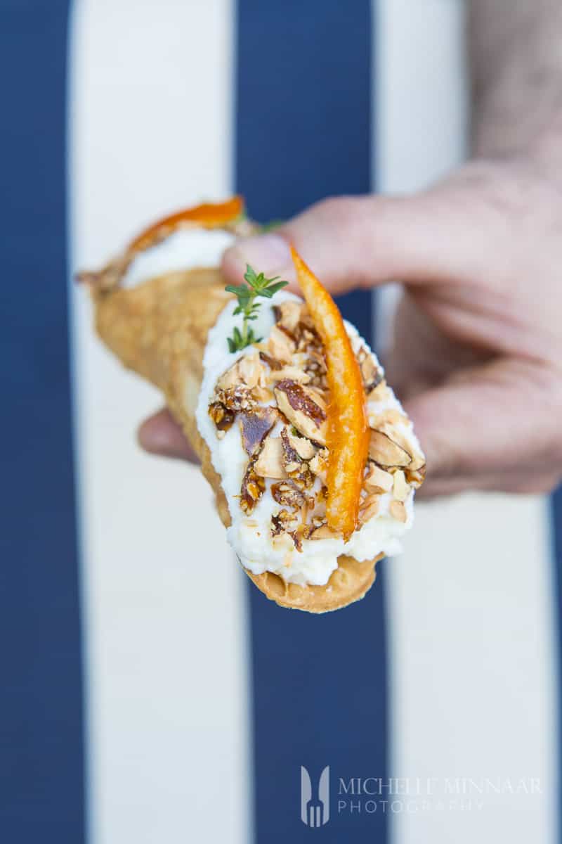 A close up of a Sicilian cannoli