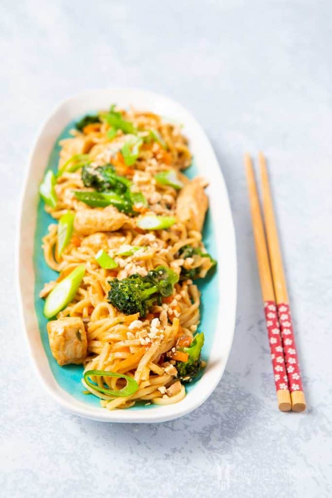 A plate of bami goreng with chopsticks 