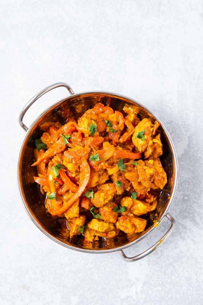 Aerial view of Chicken Jalfrezi in a metal bowl 