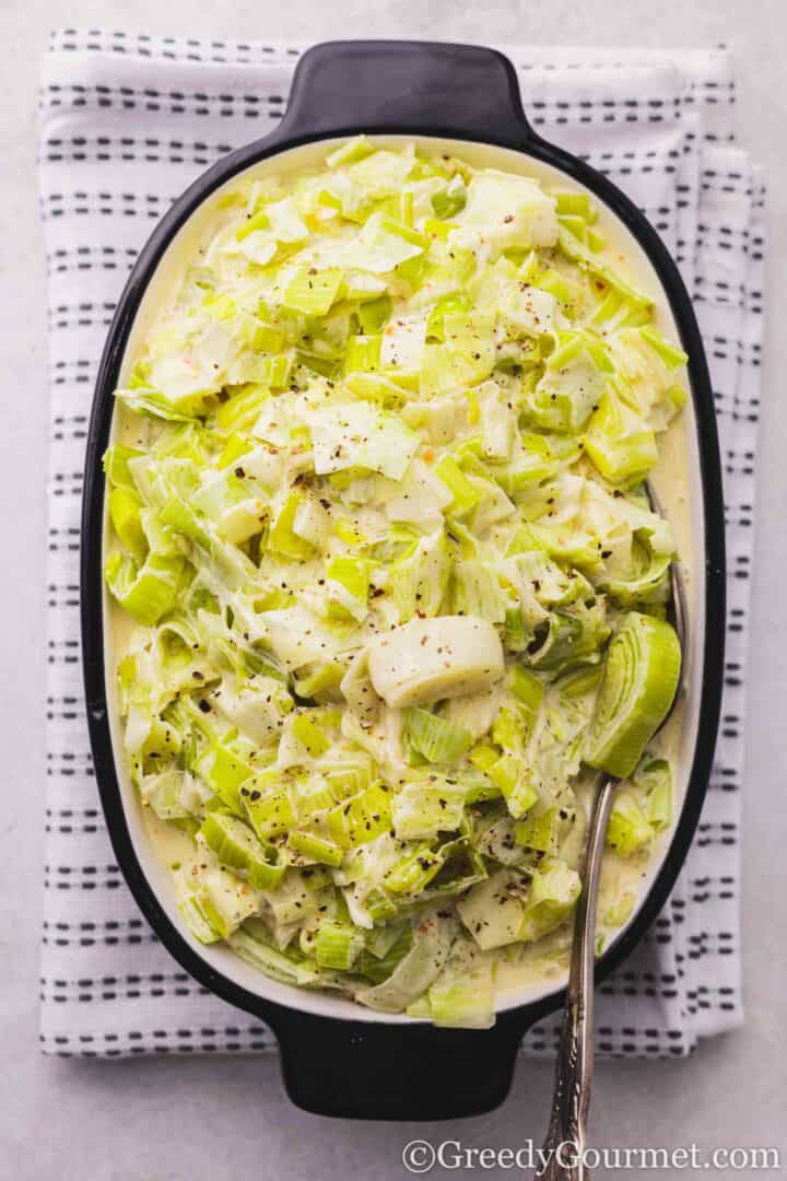 Creamed Leeks in a black dish.