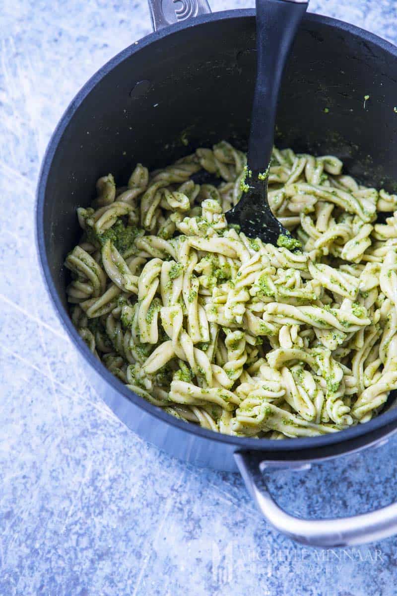 Fresh fusilli pasta in a bowl with pesto sauce