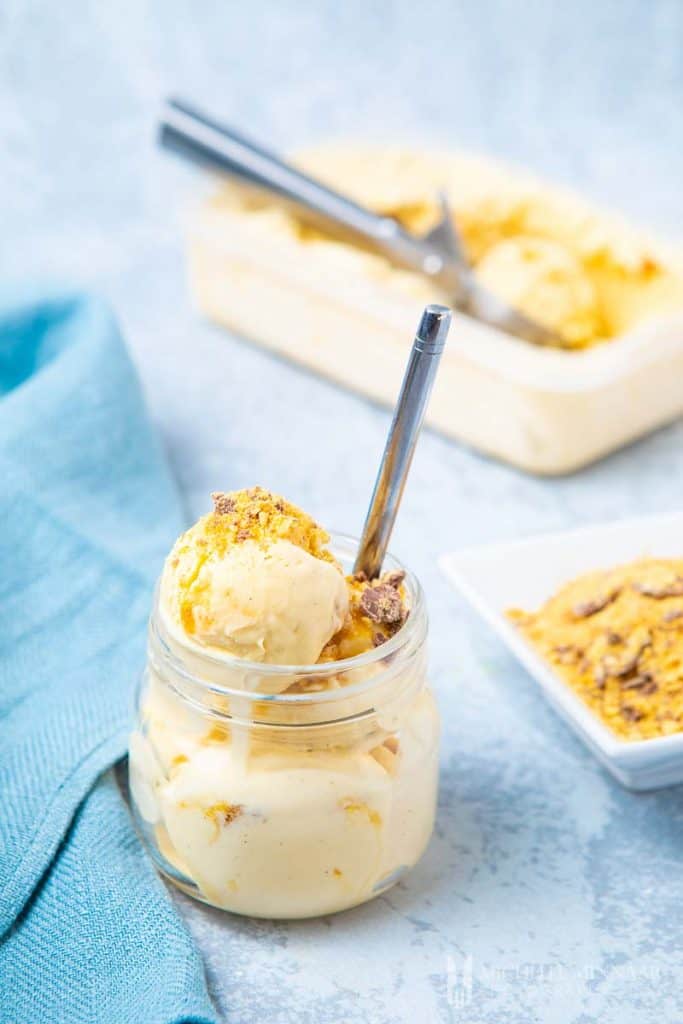 A glass jar full of caramel hokey pokey ice cream