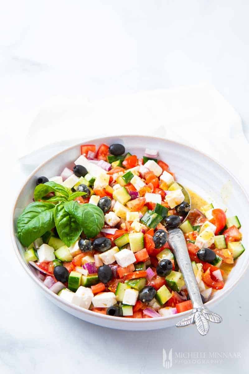 A large colorful bowl of Mediterranean salad